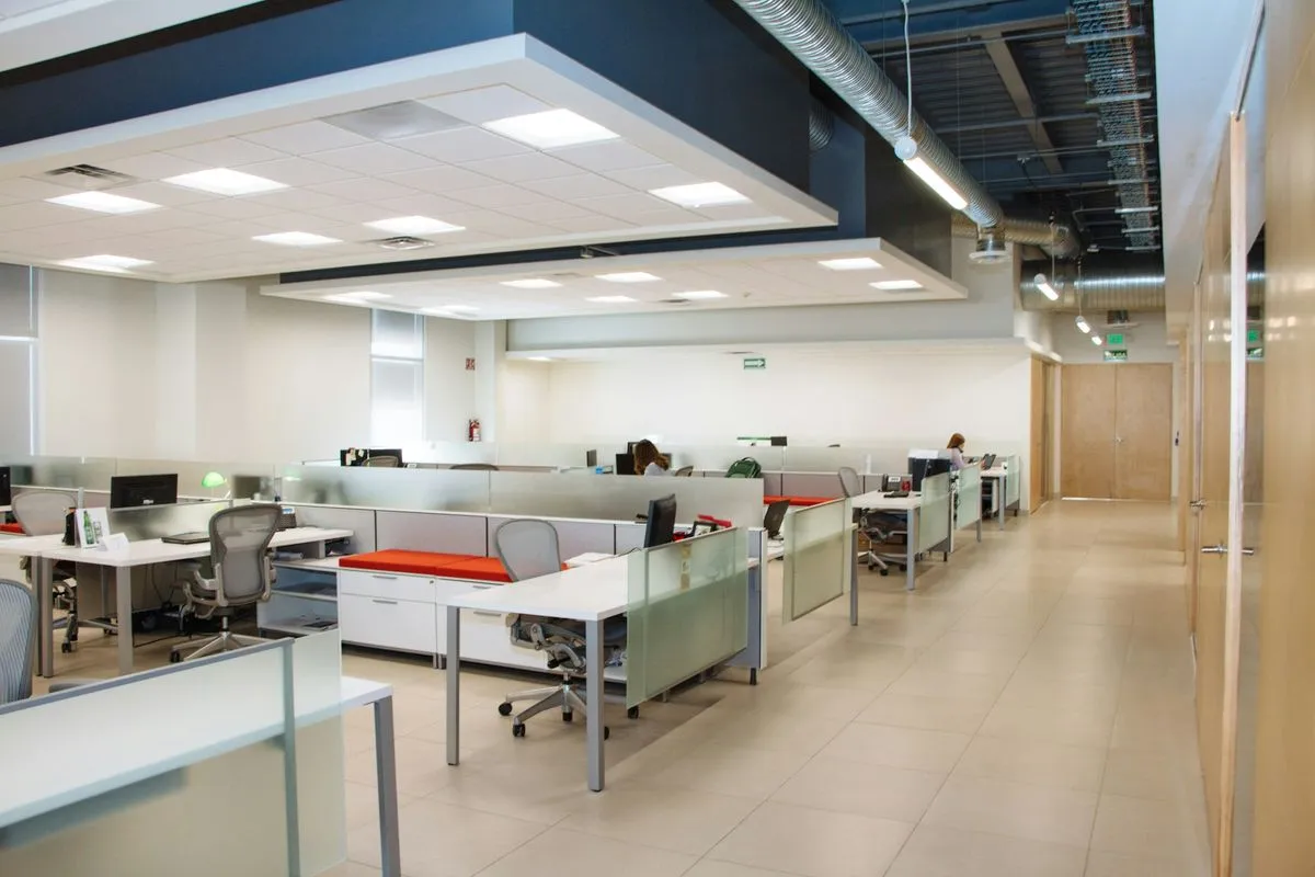 Clean open plan office with polished floors and tidy desks after hours